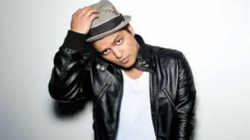 runo Mars, an American singer-songwriter and performer known for his smooth vocals, electrifying stage presence, and chart-topping hits.