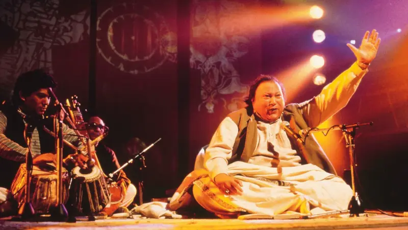 Nusrat Fateh Ali Khan, legendary Pakistani Qawwali singer, known for his soulful Sufi music and powerful vocals.